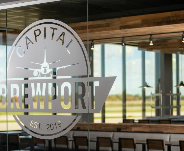 Capital Brewport logo on glass door of restaurant.