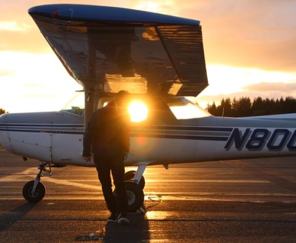 Small plane on runway at sunset